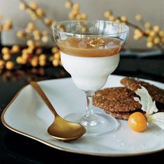 there is a dessert on the plate with a spoon next to it and some cookies