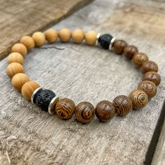 Handmade | Natural | Lifetime Warranty The Westland Collection brings a stylish beaded bracelet to your wrist featuring 8mm beads. Designed with black volcanic lava rock, brown zebrawood, and light cedar beads accented by silver spacers. Made from high quality materials with a fit that you will love. No other bracelet feels or looks this great on your wrist. Materials | Lava Rock, Zebrawood, Cedar, & Silver SpacersWidth | 8mm BeadsSize | Multiple Sizes Available Cord | Black Elastic Stretch Cord Mala Beads Bracelet, Wood Bead Bracelet, 8mm Beads, Zebra Wood, Mala Bracelet, Lava Rock, Mala Beads, Wooden Beads, Wood Beads