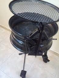 a large black grill sitting on top of a tiled floor next to a white wall