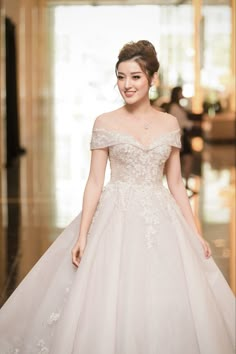 a woman in a wedding dress is smiling