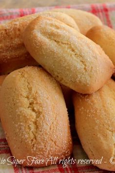 a pile of cookies sitting on top of a red and white checkered cloth