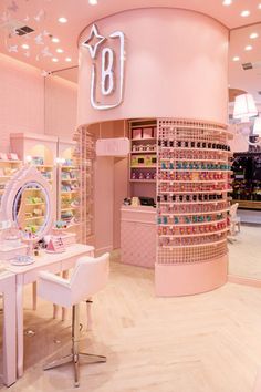 the inside of a cosmetics store with pink walls