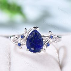 Elegant Pear Shaped Lapis Lazuli Ring Vintage Unique Twig Engagement Ring Leaf Cluster Sapphire Wedding Ring Women Blue Gemstone Branch Ring ≫≫ Item Details  Make every ring to order, all rings are handmade in the United States.  Metal: Solid 10K & 14K & 18K Gold  Gold Color: Rose gold, Yellow gold, White gold ➽ Center Stone 6x8mm pear shaped Natural Blue Lapis Lazuli stone ➽ Accent Stone:  lab sapphire Need a matching band? https://www.etsy.com/listing/1239338019/twig-branch-diamond-wedding-wed Blue Safire Wedding Ring, Dark Blue Wedding Ring, Pear Shaped Sapphire Engagement Rings, Wedding Rings With Sapphires, Blue Sapphire Engagement Ring Vintage, Blue Engagement Ring Sapphire, Wedding Rings Non Traditional, Saphire Engament Ring Set, Blue Sapphire Rings Engagement