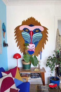 a living room with a lion head on the wall and plants in vases next to it