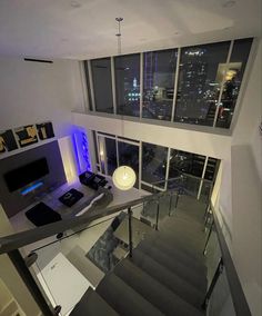 a living room filled with furniture next to a window covered in glass and metal railings