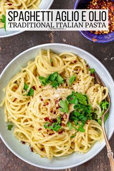 two bowls filled with spaghetti and garnished with parmesan cheese, basil