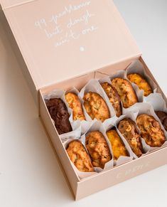 a box filled with lots of different types of doughnuts in it's wrappers