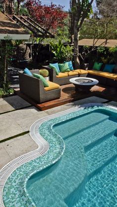 an outdoor living area with couches and a swimming pool