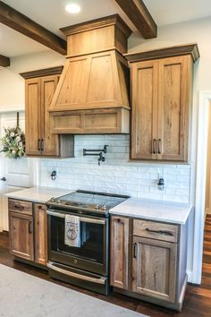 a kitchen with wooden cabinets and white counter tops, an oven and dishwasher