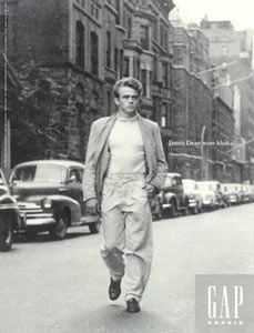 an old photo of a man walking down the street