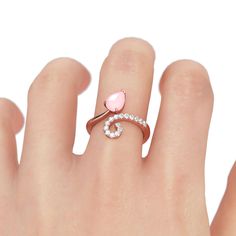 This ring is a open ring but can't be adjusted. You can choose your size according to the size guide.Dainty and delicate, this little cocktail ring will draw your eyes at first sight. Crafted in warm rose gold tone sterling silver, this asymmetric ring features a water-drop center stone and a wave design under the center stone. Treat yourself a holiday gift with this little lovely piece.Carat Weight: 1.45 ctStone Size: 6*8 mmStone Type: Jeulia® StoneNumber of Stones: 1 Stone Color: Fancy PinkSto Dainty Open Crystal Ring For Proposal, Elegant Pink Midi Rings For Anniversary, Elegant Pink Midi Rings, Elegant Pink Open Midi Rings, Delicate Adjustable Open Heart Ring, Pink Open Ring Midi Rings For Wedding, Adjustable Pink Rings For Proposal, Dainty Pink Open Heart Ring, Dainty Pink Heart Open Ring