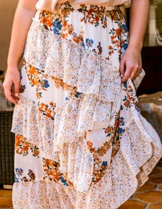 Beautiful & Timeless Floral print mixed, midi skirt featuring waist elastic, ruffle detailed, asymmetrical 100% Polyester Imported Measurements Approx.1X- Waist: 34" Hips: 54" Inseam: 36.5"2X- Waist: 36" Hips: 56" Inseam: 36.5"3X- Waist: 38" Hips: 58" Inseam: 36.5" White Ruffled Midi Bottoms, Flowy Ruffled Midi Maxi Skirt, White Ruffled Midi Length Bottoms, Flowy Ruffled Midi Length Skirt, Brunch Dress With Ruffled Relaxed Skirt, White Asymmetrical Skirt With Floral Print, White Asymmetrical Floral Print Skirt, Flowy Ruffle Midi Dress, White Floral Print Asymmetrical Skirt