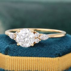 a diamond ring sitting on top of a blue cushion