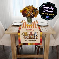 a table with a family name sign on it and flowers in a vase at the top