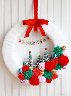 the christmas wreath is made with yarn and beads