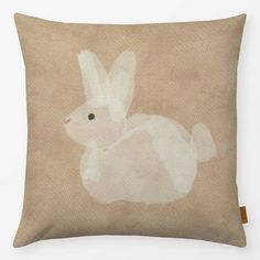 a pillow with an image of a rabbit on it