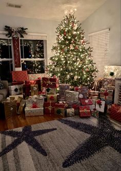 a christmas tree with presents in front of it