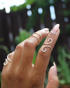 "This listing is for one (1) unique and eye-catching statement ring. The Silver Coiled Midi Ring can be ordered in any normal ring size or midi ring size. Your choice of Silver Plate or Sterling Silver wire is hand shaped in a \"S\" formation, and looks great alone and paired with other rings or alone. Due to the open shape, the ring is slightly adjustable, and great to give as a gift! Specify ring sizes during checkout: An unspecified order will revive a most midi ring size 3/4 Nickel free." Modern Twist Wire Wrapped Rings As Gift, Wire Wrapped Rings As A Modern Gift, Adjustable Midi Rings With A Modern Twist For Gifts, Modern Twist Adjustable Midi Rings As Gift, Adjustable Modern Twist Stackable Toe Rings, Hand Wrapped Open Ring Jewelry, White Modern Twist Ring Jewelry, Adjustable Hand Wrapped Midi Rings, Handmade Open Ring With Modern Twist