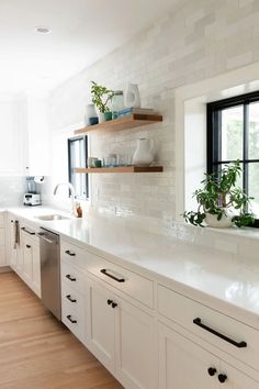 a kitchen filled with lots of white counter top space