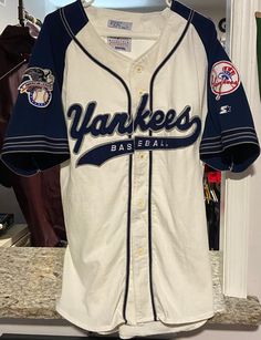 a baseball jersey that is on display in a room with other sports equipment and memorabilia