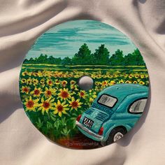 a painting of a blue truck in a field of sunflowers