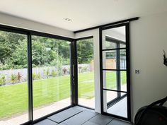 an empty room with sliding glass doors leading to the backyard