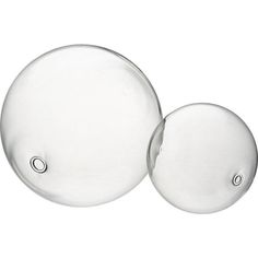 two clear glass balls sitting next to each other