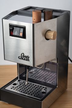 an espresso machine sitting on top of a wooden table