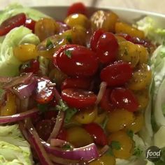 a salad with tomatoes, lettuce and onions