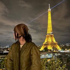 a woman standing in front of the eiffel tower