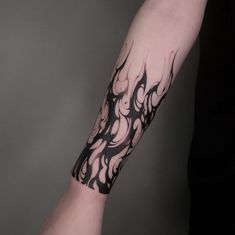 a person with a black and white tattoo on their arm