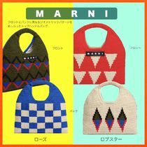 three knitted bibs in different colors and patterns, with the words marni written on