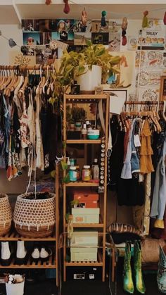 an organized closet with clothes, shoes and other items on shelves in front of it