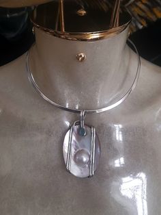 Vintage early Y2k Silver 925 necklace choker with oversized pendant, marked. Handmade by jeweller and one of a kind. It features a silver band with a mother of pearl oversized pendant, that incorporates a pearl and it is surrounded by a silver band. It also decorated with a small green stone, that I don't what it is... No closure, it just holds nicely on the neck. Pendant length 7cm/2.8" In very good condition. If you have any questions please feel free to contact me, thank you for watching. Int Neck Pendant, Silver 925 Necklace, Necklace Choker, Green Stone, Silver Band, Silver 925, Mother Of Pearl, Jewelry Necklace Pendant, Choker Necklace