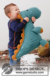 a little boy holding onto a stuffed animal