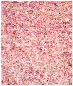 an area rug with pink and red flowers on the top, in front of a white background