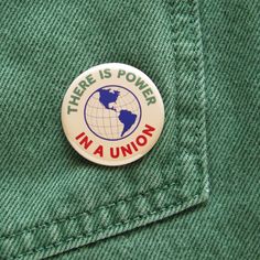 there is power in a union button on the lapel of a green jacket,