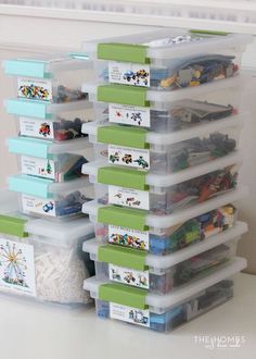 a stack of plastic storage containers filled with toys