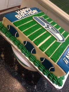 a birthday cake that is shaped like a football field