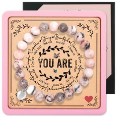 a card with the words you are surrounded by beads