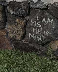 a stone wall with graffiti on it that says, i am his he is mine