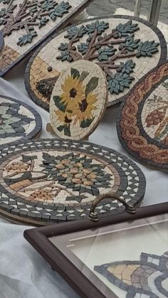 several decorative plates are on display for sale