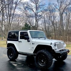 a white jeep parked in a parking lot