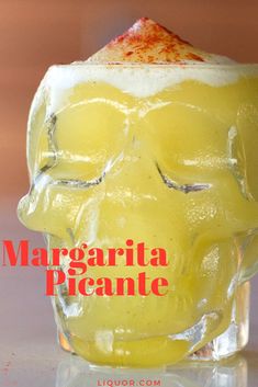 there is a glass with some liquid in it and the words margarita picante written on it