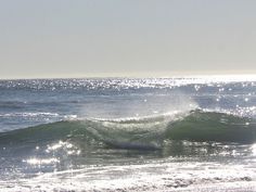 a person riding a wave on top of a surfboard