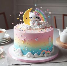 a hello kitty cake with rainbow and stars on it