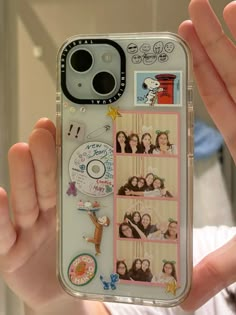 a person holding up a cell phone case with pictures on the front and back of it