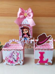 some little boxes that are decorated with pictures and pink ribbon on top of each box