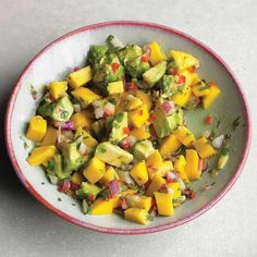 a bowl filled with fruit and vegetables on top of a table