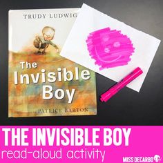 the invisible boy book is next to a pink marker and some paper on a table